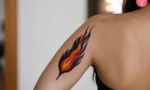 Tatuaje de fuego estilizado en el brazo de una persona.