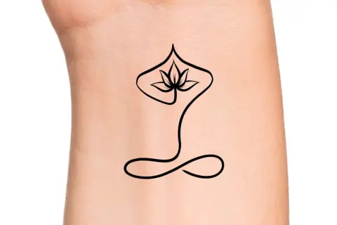 Un delicado tatuaje de meditación con una flor de loto estilizada y un símbolo de infinito en la muñeca, evocando paz interior.