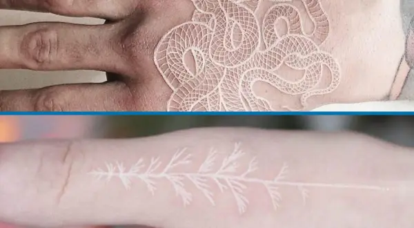 Un delicado tatuaje blanco de serpiente enredada en una mano y una rama de árbol en un dedo.